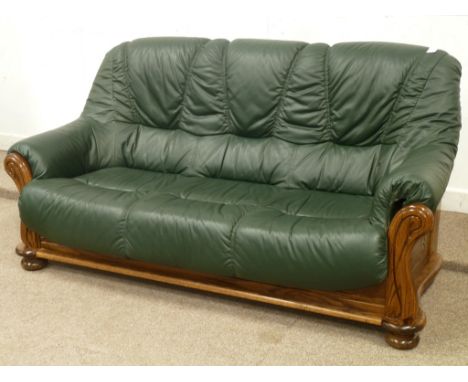 Three seat wood framed sofa, (180cm), upholstered in green leather, matching two seater (130cm), and armchair with footstool