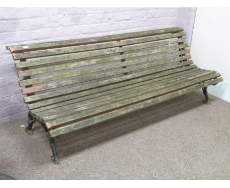 Early 20th century cast iron and wood slatted garden bench with curved seat, W200cm