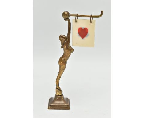 AN ART DECO BRASS FEMALE NUDE BRIDGE MARKER, the figure holding a bar with five double sided suits / 'NO TRUMPS' celluloid ma