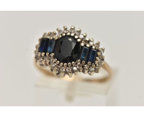 A 9CT GOLD DIAMOND AND SAPPHIRE CLUSTER RING, oval and baguette cut sapphires set with a surround of single cut diamonds, pro