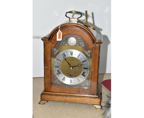 AN ELLIOTT OF LONDON BRACKET CLOCK MADE FOR MAPPIN &amp; WEBB LTD. a brass arched dial with cherub spandrels and silvered cha