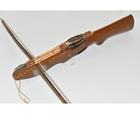 A SMALL CROSSBOW, in working order complete with four arrows, the stock is engraved Philippines but lacks a makers name  Purc