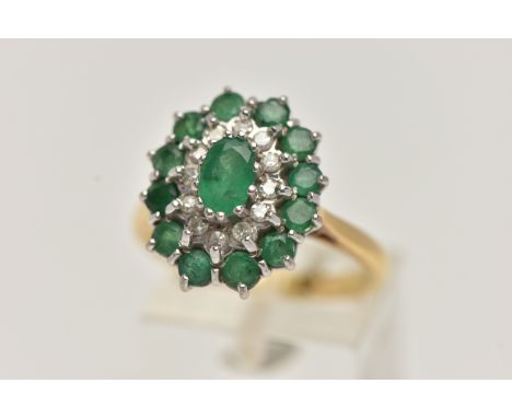 AN 18CT GOLD EMERALD AND DIAMOND CLUSTER RING, oval cluster set with a central oval cut emerald, in a surround of single cut 