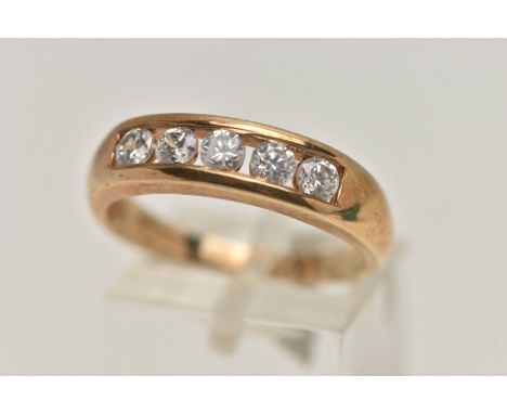 A 9CT GOLD CUBIC ZIRCONIA RING, designed with  row of five circular cut, colourless cubic zirconia, to a polished band, hallm