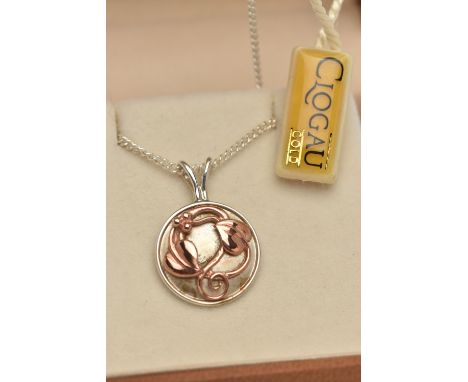 A SILVER 'CLOGAU' PENDANT NECKLACE, the circular two tone floral pendant, signed 'Clogau', fitted with a split V bail, suspen