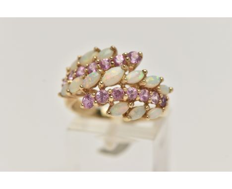 A 9CT GOLD OPAL AND PINK SAPPHIRE DRESS RING, designed with two rows of asymmetrically set circular cut pink sapphires, and t