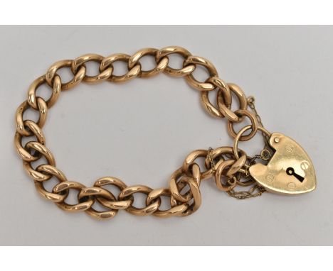 A 9CT GOLD CURB LINK BRACELET, solid links, stamped 9.375, fitted with a heart padlock clasp, hallmarked 9ct London, with add