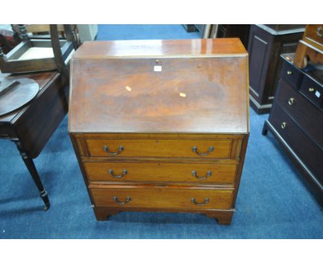 A 20TH CENTURY MAHOGANY BUREAU, the fall front door enclosing a fitted interior, above three drawers, on bracket feet, width 