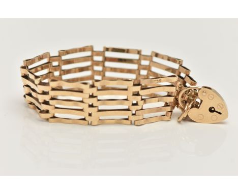 A 9CT GOLD GATE BRACELET, five bar gate bracelet, stamped 9ct, fitted with a heart padlock clasp, hallmarked 9ct London, with