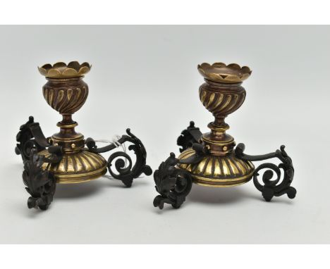 A PAIR OF LATE 19TH CENTURY BRASS AND WROUGHT IRON DWARF CANDLESTICKS, in the style of W.A.S. Benson, with wavy rim above spi