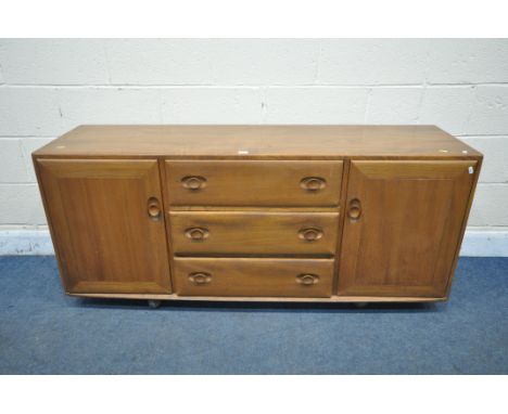 A MID-CENTURY ERCOL ELM ROLLING SIDEBOARD, cupboard doors flanking three drawers, width 156cn x depth 46cm x height 69cm (con