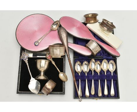 AN ASSORTMENT OF SILVER ITEMS, to include a cased egg cup, a cased set of six teaspoons, four assorted napkin rings, two maso