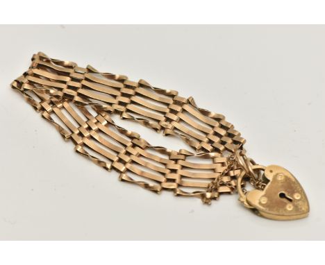 A YELLOW METAL GATE BRACELET, five bar gate bracelet, some links stamped 9.375, approximate width 16.8mm, fitted with a gold 