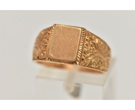 A YELLOW METAL SIGNET RING, polished rectangular signet to scrolling floral shoulders and polished band, stamped 750, ring si