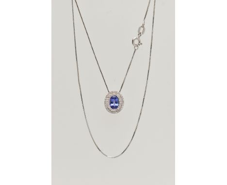 AN 18CT WHITE GOLD, TANZANITE AND DIAMOND CLUSTER PENDANT NECKLACE, the pendant of an oval form, set with an oval cut tanzani