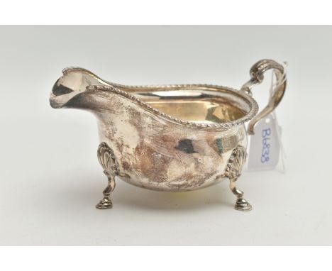 A MID 20TH CENTURY SILVER GRAVY BOAT, polished form, gadrooned rim, on three cabriolet legs, fitted with a scroll handle, hal