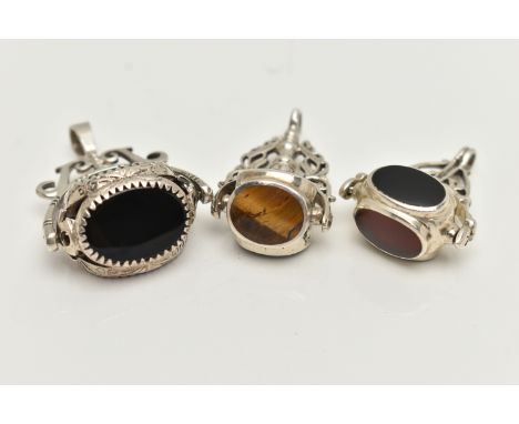 THREE WHITE METAL SWIVEL FOB PENDANTS, each set with semi-precious gemstones such as bloodstone, carnelian, tigers eye, mothe