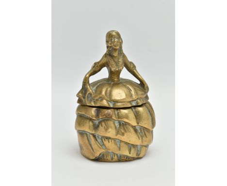 AN EARLY 20TH CENTURY BRASS INKWELL IN THE FORM OF A CRINOLINE LADY, with hinged skirt, the interior with ceramic inkwell pri