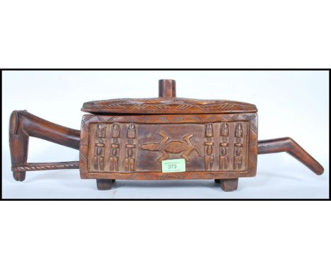 A Dogon Ceremonial Wood chest of rounded rectangular form on shaped block feet, relief-carved with figural friezes carved wit
