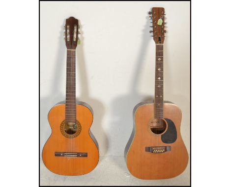 A twelve string acoustic guitar by B &amp; M Maverick of typical form having chrome tuning pegs and mother of pearl fret mark