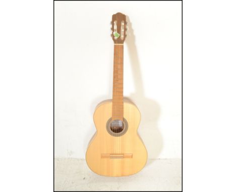 Hokada- An acoustic six string guitar having solid spruce top laminated back &amp; sides to the&nbsp;shaped&nbsp;hollow body 