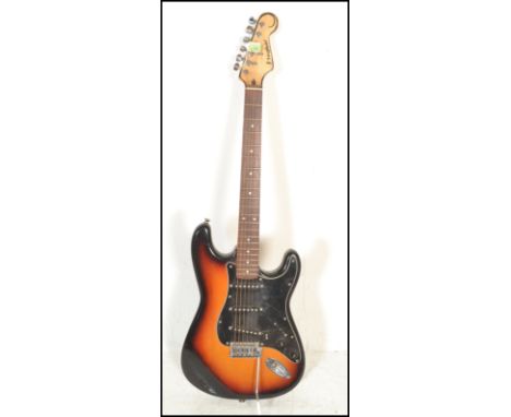 A vintage Westfield six string electric guitar having a shaped burnt wood effect body and a black scratch guard with chrome t