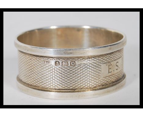 A collection of silver napkin rings to include an engine turned ring engraved with E. S. initials(hallmarked Birmingham 1940)