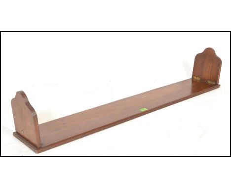 An early 20th Century large metamorphic mahogany book trough of simple form, single shelf with folding ends. 123cms wide.