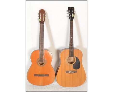 A vintage Dulcet classic six string acoustic guitar model 3057 having a shaped hollow body with paper label to the interior. 