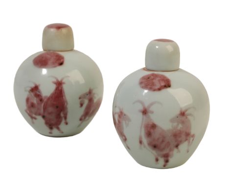 A PAIR OF CHINESE PORCELAIN FLASKS each with an ovoid body decorated in iron red and black with three goats in red, the domed