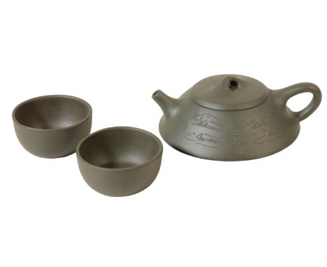 A CHINESE REPUBLIC "YIXING" TEAPOT and a pair of teabowls ensuite, each with a green body, the teapot with etched decoration 