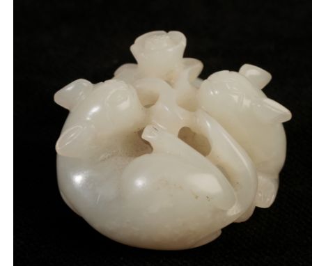 A SMALL WHITE JADE CARVING OF TWO CATS, QING DYNASTY finely carved with the two felines coiled around a flowering stem, one w