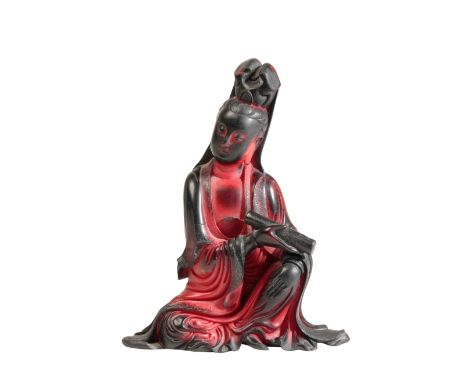 A CHINESE RED 'LACQUER' SEATED GUANYIN the underside with seal marks and inscription, 11cm high