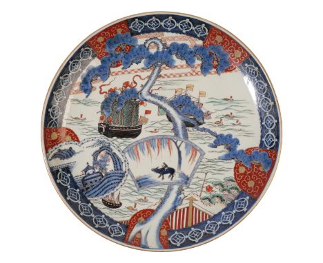 A JAPANESE PORCELAIN CHARGER decorated in polychrome enamel underglaze blue and gilt with European men o'war, junks, a gnarle
