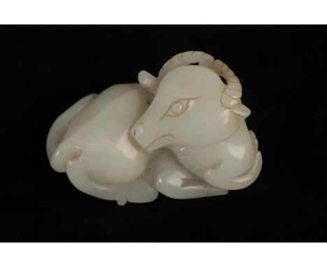 A CHINESE PALE CELADON JADE BUFFALO, the head turning across the back of the recumbent beast, with a soft lustrous polish, Qi