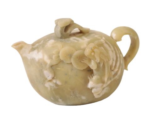 A CHINESE GREEN SOAPSTONE TEAPOT the gourd-shaped body mottled in white and carved with a coin toad climbing across lily pads