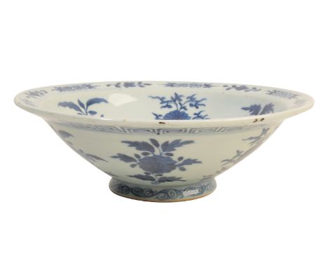 A CHINESE BLUE AND WHITE BOWL with heaped and piled decoration of floral sprays, the reverse similarly decorated with a key p