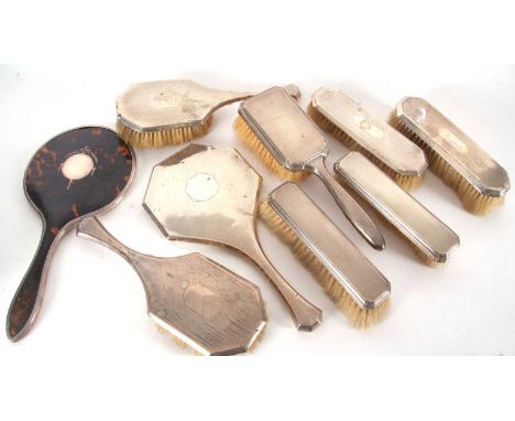 Mixed Lot:  Three silver backed dressing table hair brushes with engine turned decoration, four silver backed clothes brushes