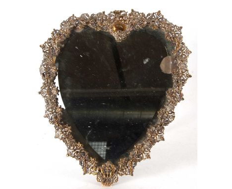 An antique formerly silver plated heart shaped easel backed dressing table mirror having bevelled cut mirror edge, framed wit