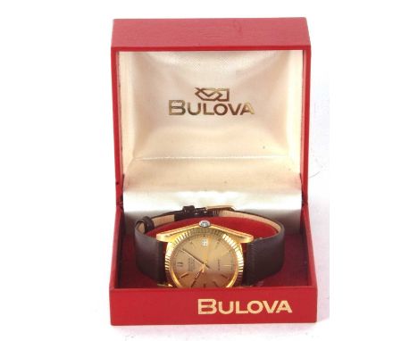 A Bulova Super Seville calendar gents wristwatch, the watch has a quartz movement, gold coloured dial with baton hour markers