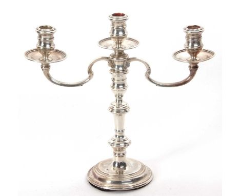 A silver three light candelabra standing on a plain circular foot, the column with three knops, top section detachable, Londo