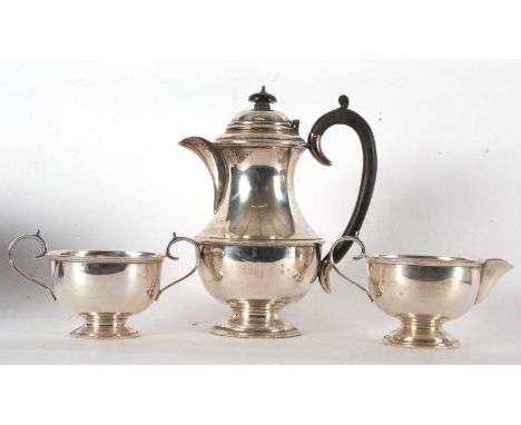 A three piece George V tea service of plain baluster form with beaded edges, the coffee pot Birmingham 1931, milk jug Chester