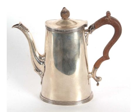 A George V silver small coffee pot of plain oval form with reeded edges standing on a collet foot having a fruit wood handle 