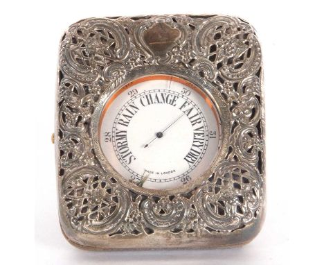 An Edwardian silver framed and leather Goliath pocket watch holder with pieced decoration having sea scroll and trellis decor