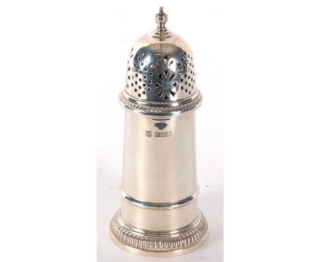 An Elizabeth II silver caster of lighthouse form having pull off pierced lid, urn finial and gadrooned borders, hallmarked fo