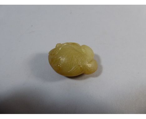 A Chinese Carved Jade Study of a Fish Beside Lily Pad. 5cm Long 