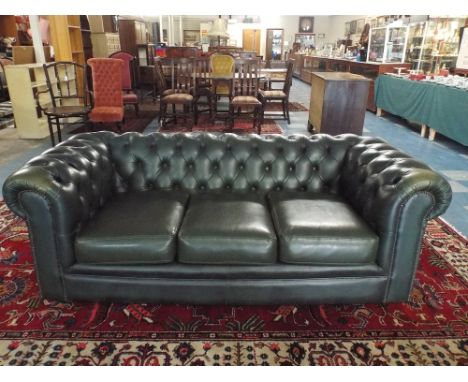 A Button Upholstered Green Leather Chesterfield Three Seater Settee