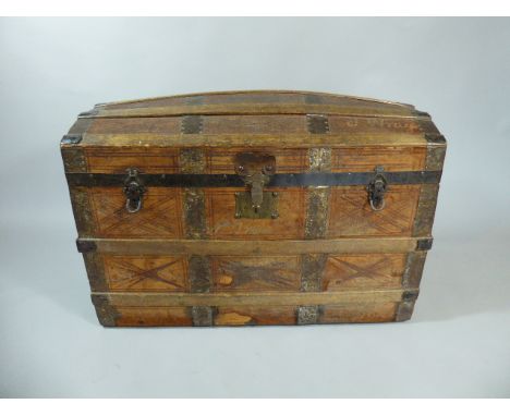 A Vintage Dome Topped Travelling Trunk with Tooled Leather Covering having Iron and Wooden Mounts. Fitted Interior with Compa