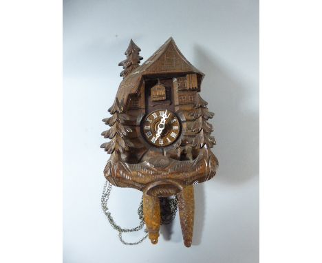 A Carved Black Forest Cuckoo Clock with Clockwork Two Weight Movement. 27cm High