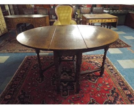 A Titchmarsh Style Oak Drop Leaf Gate Leg Table with Oval Top on Turned Supports. 105x37.5cms (When Closed)
